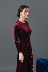 Elegant velvet midi dress with pearl embellishments and fitted long sleeve silhouette